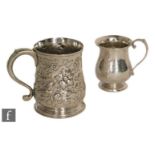 A Victorian hallmarked small silver tankard with embossed foliate decoration, height 9cm, with a