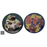 Two Moorcroft plates, the first decorated in the Clematis pattern, retains Potter to the Late