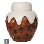 A small Moorcroft Pottery ginger jar and cover formed as a Christmas Pudding, designed by Julie