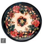 A Moorcroft Pottery shallow plate decorated in the Oberon pattern designed by Rachel Bishop,