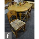 A 1920s light oak oval dining table on slender cabriole legs and pad feet with two extra leaves,