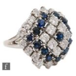 An 18ct sapphire and diamond cluster ring, central sapphire within a eight diamond surround, a