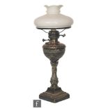 A silver plated oil lamp converted to electricity, square stepped base below baluster Corinthian