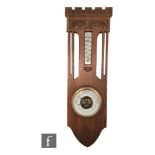 An early 20th Century Dutch carved oak aneroid barometer with thermometer with Secessionist style