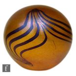 A contemporary Glassform paperweight by John Ditchfield of spherical form, decorated with pulled