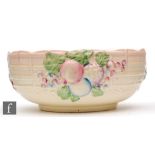 A Clarice Cliff shape 883 fruit bowl relief moulded with fruit over a basket weave ground picked out