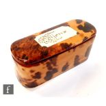 A 19th Century rounded rectangular tortoise shell box with hinged lid inset with an ivory panel