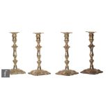 A set of four Victorian hallmarked candlesticks, a each with scalloped square base with shell