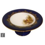 An early 20th Century Royal Worcester comport with splayed foot, knopped stem and shallow dish