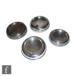 A collection of four Art Deco silver hallmarked cendriers/ashtrays, each of circular stepped form,