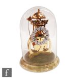 A late 20th Century skeleton mantle clock by Thwaites and Reed, hammer strike to a bell, in glass