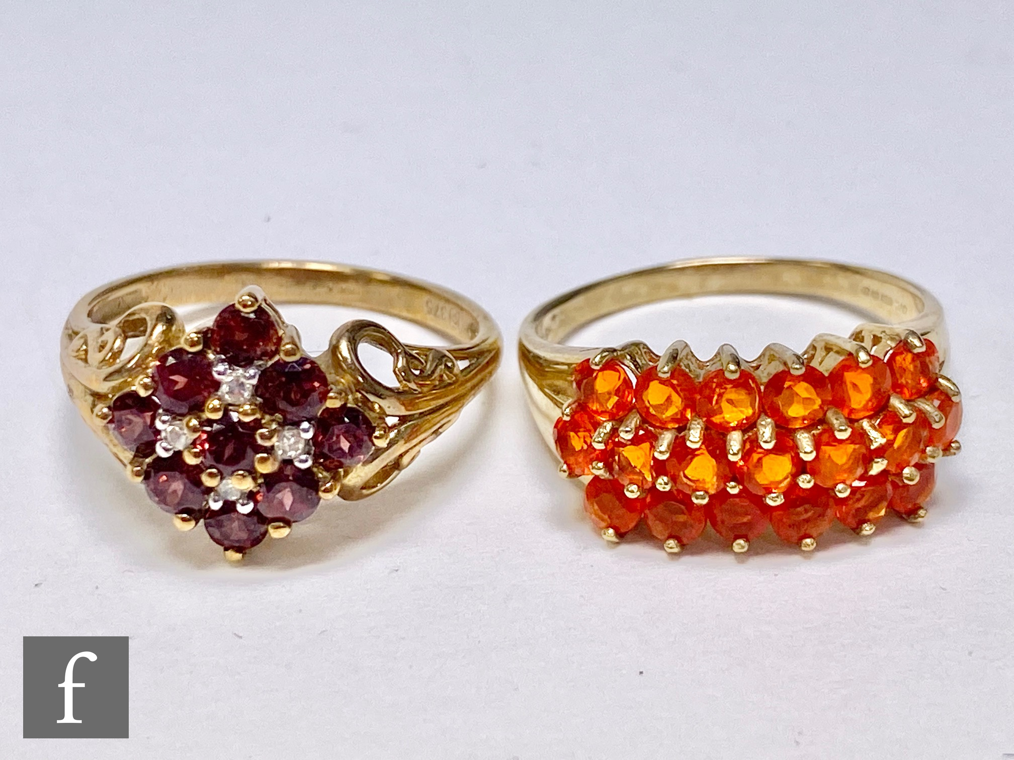 A 9ct hallmarked garnet and diamond cluster ring with a 9ct ring set with three rows of fire