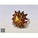 A 9ct citrene cluster ring with central square cut citrene within a pear and marquise cut border,