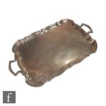 A hallmarked silver twin handled tray of plain form with central presentation engraving and