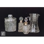 An early 20th Century glass jug of tapering form with applied scroll handle, cut and polished with