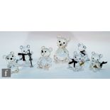 A collection of Swarovski Teddy Bear figures comprising four teddy bears with tartan scarves