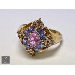 A 9ct hallmarked sapphire cluster ring comprising pink, blue and yellow sapphires to an off set