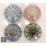A collection of four 20th Century Scottish glass paperweights, each decorated with a millefiori