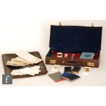 A collection of Masonic regalia in leather cases to include enameled jewels, aprons books etc. (qty)