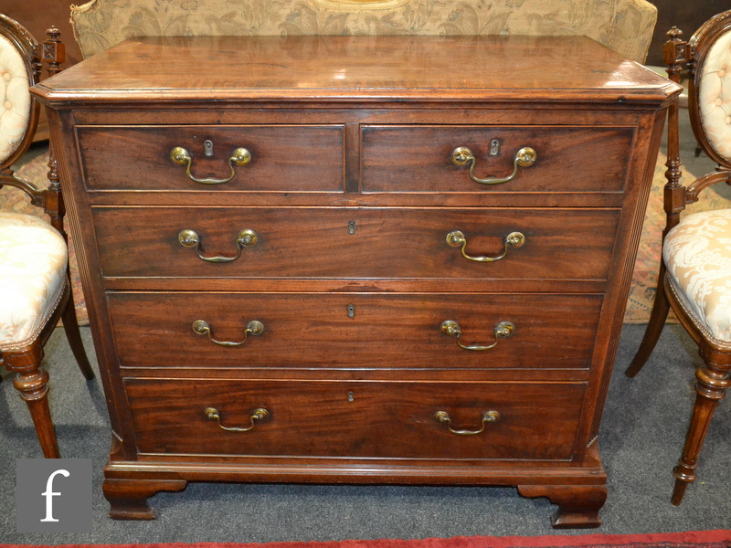 A George III crossbanded mahogany chest of two short and three long drawers flanked by reeded