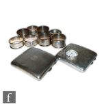 A small parcel lot of silver items, two cigarette cases, eight napkin rings and a fob watch,