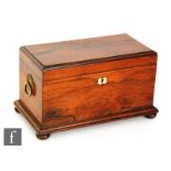 A 19th Century rosewood tea caddy fitted with two separate canisters and a central glass mixing bowl