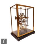 A late 20th Century brass skeleton clock with grasshopper escapement, eight day single fusee