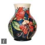 A Moorcroft Pottery vase of globe and shaft form decorated in the Simeon pattern designed by