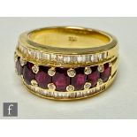 An 18ct ruby and diamond ring, eight graduated oval claw set rubies each flanked above and below