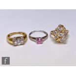 Three 14ct cubic zirconia rings to include a cluster and a pink solitaire example, total weight 13.