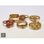 Six assorted 9ct rings to include flower and buckle examples, total weight 19.5g, with a similar