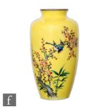 A 20th Century Chinese cloisonne vase decorated with a finch perched on a blossoming lotus branch on
