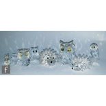 A collection of Swarovski animal ornaments including seven various owls, cats, rabbits and hedgehogs