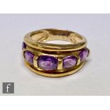 A 9ct hallmarked five stone amethyst ring, graduated stones to a wide shank, weight 4.8g, ring