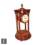 An Edwardian mahogany mantle clock, the circular enameled dial in a rotunda style pillar case on