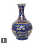 A late Qing Dynasty (1644-1912) Chinese powder-blue bottle vase, rising from a high footring, the