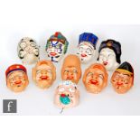 A collection of 20th Century painted papier mache face masks.