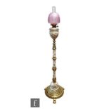 A late 19th Century Royal Worcester blush ivory floor standing oil lamp, the reservoir with sprays