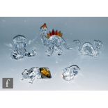 A group of Swarovski animal ornaments including dinosaur, dragon, chameleon and snakes, all in