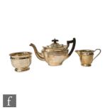 A hallmarked silver boat shaped teapot with part reeded decoration, with an associated cream and