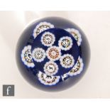 A contemporary Scottish paperweight by John Deacons, with millefiori and star cane work formed as