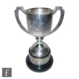 A silver hallmarked twin handled trophy, raised on a spreading circular base, engraved 'THOMAS