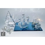 A large collection of Swarovski ornaments comprising, seven boats, vintage car and five piece