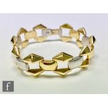 A 14ct bi-coloured flexible bracelet with nine alternate white and yellow gold cushioned rectangular