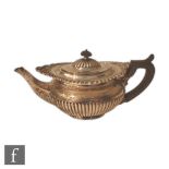 A hallmarked silver boat shaped tea pot with part fluted decoration and scalloped border, length