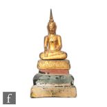 A 19th Century carved giltwood Chinese or Burmese figure of shakyamuni buddha, seated in lotus