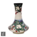 A Moorcroft Pottery vase of compressed globe and shaft form decorated in the Snowberry pattern