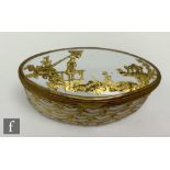 A late 18th to early 19th Century French enamel box of oval section, decorated in gilt over white