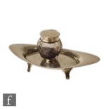 An Asprey Edwardian silver hallmarked inkwell, the oval swept stand raised on splayed supports and