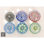 A group of six small Scottish glass paperweights, each with concentric rings of millefiori canes